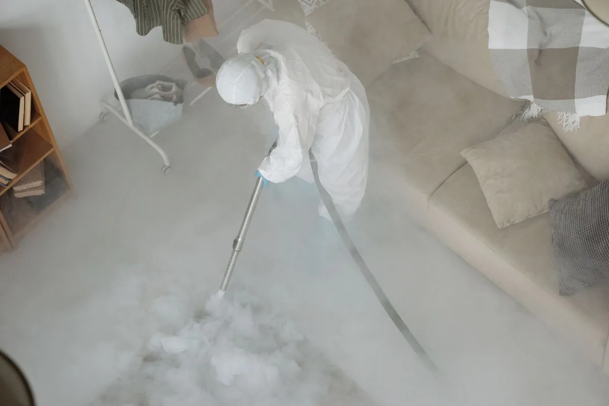 Biohazard cleanup technician in protective equipment, Good Hope, CA